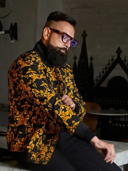 For the man who is unafraid to be bold, I design pieces that command attention. This baroque-patterned bomber jacket in black and gold offers a luxurious and confident style, proving that casual outerwear can still be a work of art.
