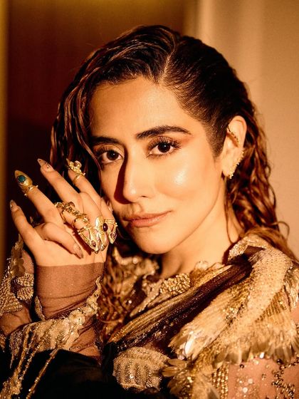 A series of images capturing the stunning Rahul Mishra Couture outfit I styled for Jonita Gandhi's performance. The detailed embroidery, flowing silhouette, and pairing with thigh-high Louboutin boots created a look that was both ethereal and powerful.