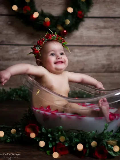 Pure happiness in a tub. This little one is having a great time during her milk bath photoshoot. Her joyful expression is what makes this image so special.