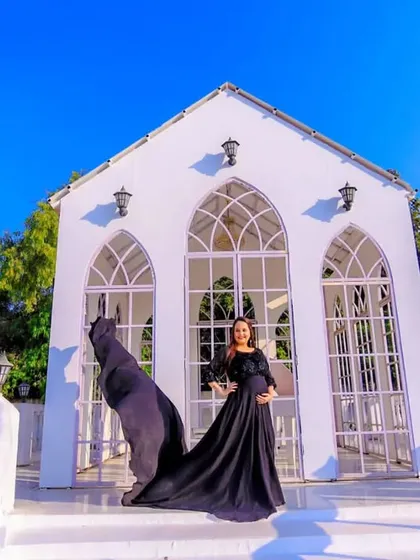 This is for the mothers who want a touch of drama and elegance. We chose an outdoor location with striking architecture to complement this beautiful flowing black gown, creating a powerful and timeless maternity portrait.