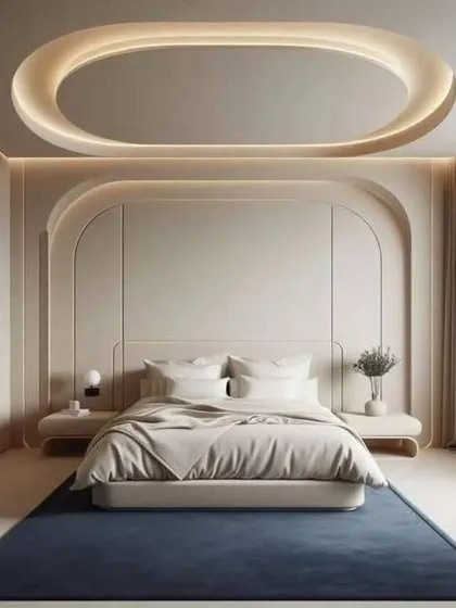 This bedroom design is all about clean lines and soft curves. The arched wall panels and oval false ceiling create a minimalist yet visually interesting space.