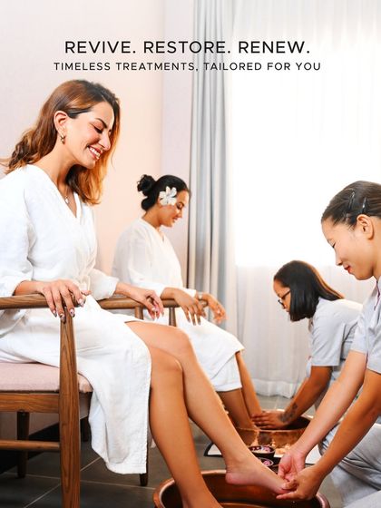 Revive, Restore, Renew. A group of friends enjoys a shared wellness experience, starting with a relaxing foot ritual. It's the perfect way to bond and rejuvenate together.