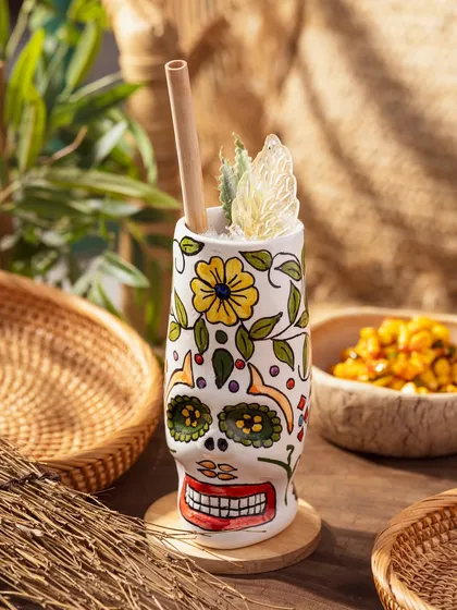 A unique skull-shaped tiki mug. This shot highlights creative glassware and is perfect for showing off a bar's personality.