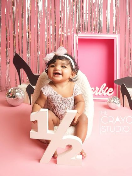 Halfway to one and already a star. This baby girl celebrates her six-month milestone in a glamorous Barbie-themed setup.