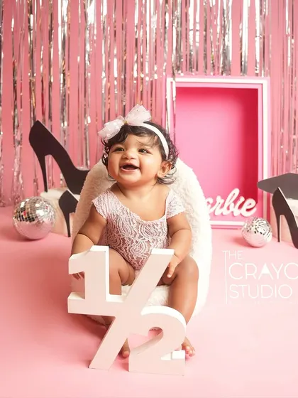 Halfway to one and already a star. This baby girl celebrates her six-month milestone in a glamorous Barbie-themed setup.