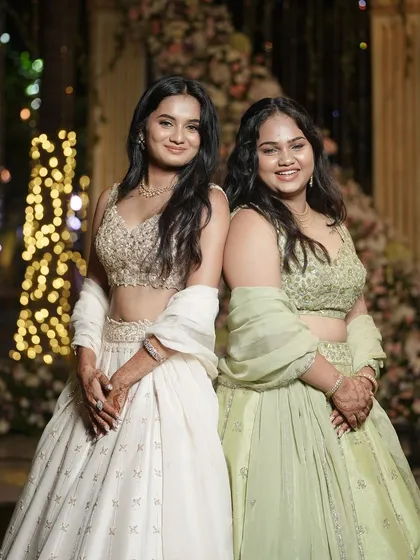 Sister goals. Two beautiful clients look magical in our raw silk lehengas in complementary shades of beige and mint green, showcasing how different colours can create a harmonious look.