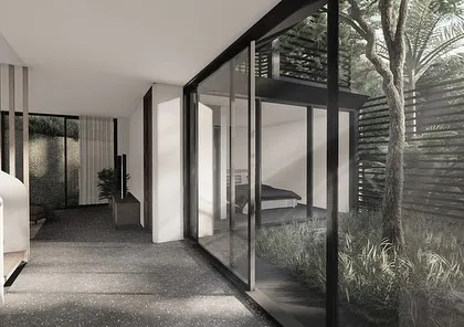 This dining area in our Kolgaon project features a long, communal table and a dramatic light fixture. The space is open to the double-height living area, creating a sense of grandeur and connection.