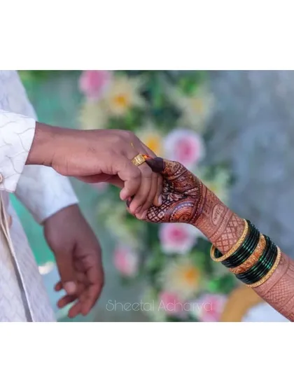 There are moments you can't put into words. A beautiful shot of the bride and groom holding hands during their engagement ceremony.