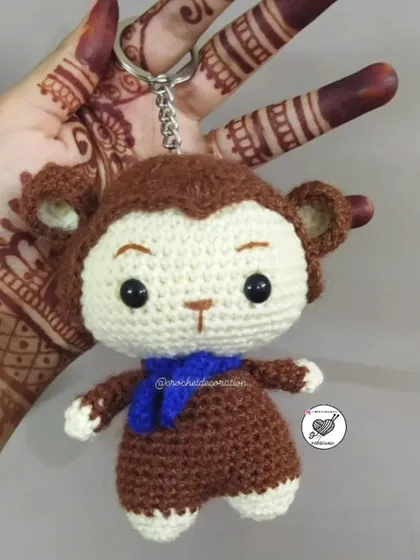 Take a little friend with you wherever you go with our crochet monkey keychain. Detailed with a tiny blue scarf, this amigurumi charm is perfect for decorating backpacks, keys, or car mirrors.