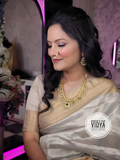A serene and beautiful festive look. The soft lighting highlights the beautiful makeup and traditional nath.