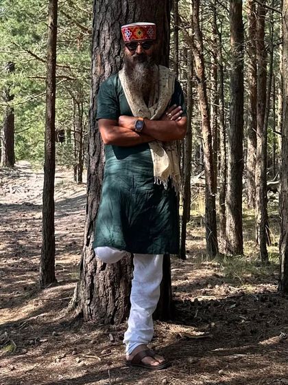 Standing confidently against a tree in the forest. The original caption is a playful warning to critics, reflecting the self-assured and sometimes humorous side of my personality.