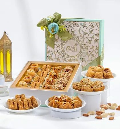 A mint-green version of our Royal Delight Hamper. The assortment includes different shapes and flavors of baklava, from rolls to nests, showcasing our variety.