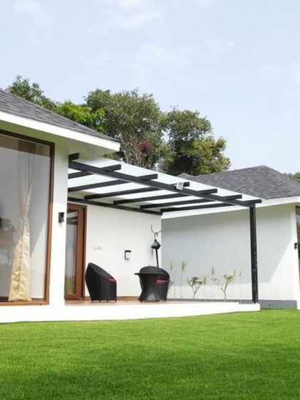 A row of premium cottages at Panorama Peaks, Coorg, showcasing their modern design and beautiful lawn.