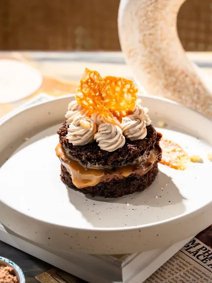 A mini chocolate and salted caramel layered dessert. The close-up shot highlights the different textures and gooey caramel.