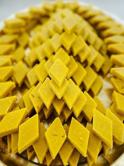 Our Badam Katli is prepared with premium almonds and has a perfectly balanced sweetness. Here, it's beautifully arranged on a platter for an event, showcasing the quality and presentation we bring to every celebration.