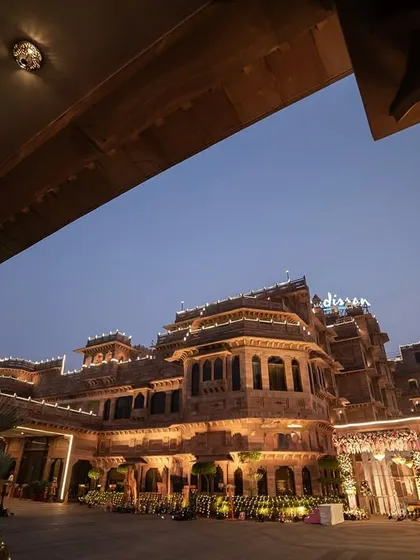 The grandeur of a palace wedding venue lit up at dusk. We don't just photograph people; we capture the entire atmosphere, ensuring the scale and beauty of your destination wedding are part of your story.