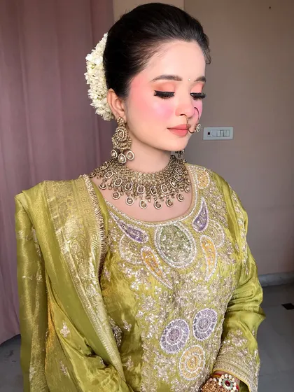 A full shot of the client, her green outfit and antique jewelry creating a beautiful, earthy look.