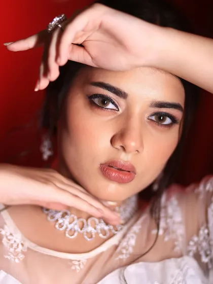 A more artistic and dramatic pose, this shot highlights the contouring and the sharp winged eyeliner that defines this modern bridal look.