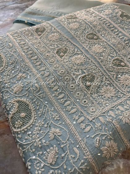 A close-up of the paisley motifs, a classic element of Chikankari design.