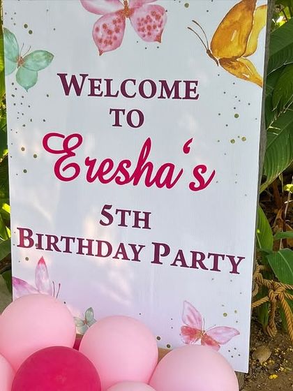 The welcome sign for Eresha's 5th birthday butterfly party, placed at the entrance of the garden venue.