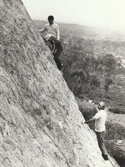 Dara Mistry spotting a younger climber. This image captures the mentorship and passing down of knowledge that has always been part of our community.