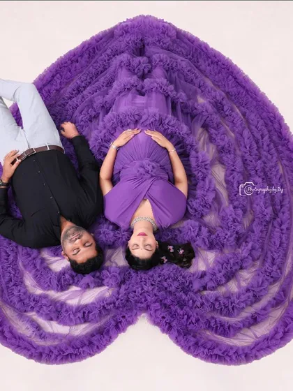 Our signature overhead "sleeping pose" with a couple. The purple ruffled gown is arranged in a heart shape, symbolizing their shared love.