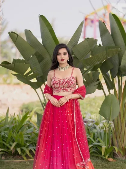 A beautiful client in a vibrant red lehenga. The delicate embroidery and classic silhouette make it a timeless choice for any celebration.