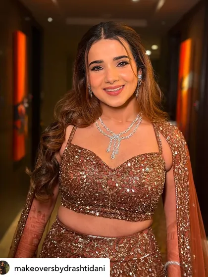 A close-up of her radiant smile. The makeup is warm and inviting, with a focus on luminous skin and beautifully defined features.