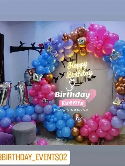 We also design trendy birthday decorations for older kids. This setup for an 11th birthday features a colorful balloon ring in blue, pink, and purple with bronze accents, and large silver foil numbers.