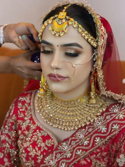 A behind-the-scenes shot of the final touches being applied to the hair, showing how the complete look comes together.