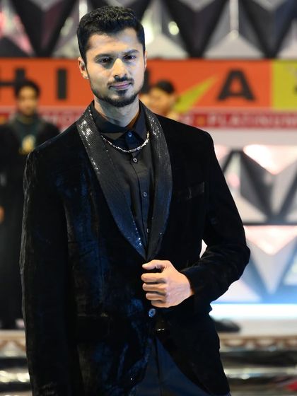A close-up shot on the ramp for Bhima Gold, highlighting the shimmer of the lapel and the overall polished look.
