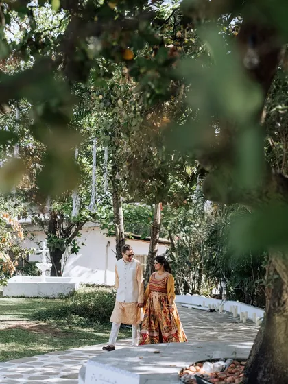 A candid shot of the couple taking a stroll during their Haldi event. I build buffer time into the schedule for these quiet moments together amidst the celebrations.