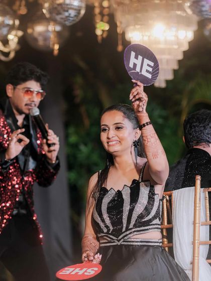 The bride's turn during the "He or She" game. This interactive game is a Sangeet favorite, always resulting in laughter and fun revelations about the couple.