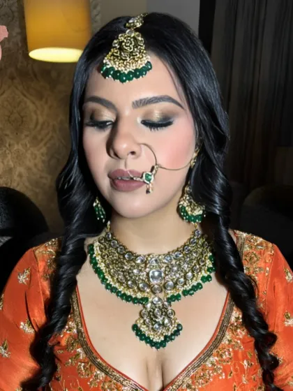 A close-up of the reception makeup, with the bride's eyes closed to show the beautiful gold and brown eyeshadow work.
