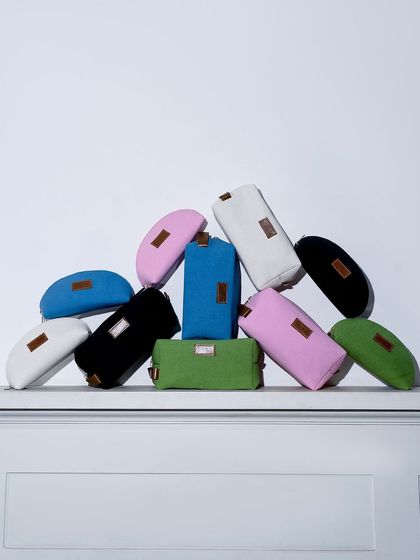 A playful stack of colorful pouches and bags. This shot is a great way to showcase the variety of colors and sizes available.