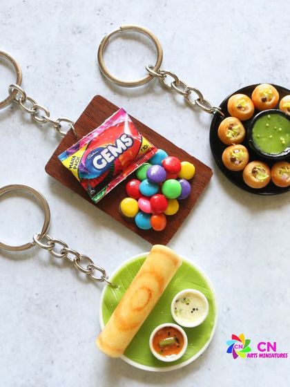 A collection of my food-themed keychains, including dosa, pani puri, and Gems.