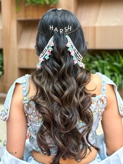 A detailed shot of the hairstyle, which includes a personalized clip with the groom's name, "Harsh."