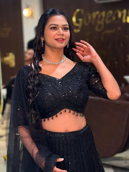 This is a great example of my HD party makeup. We created a fresh, glowing look with defined eyes and a natural lip color that perfectly complements her sparkling black lehenga. It's a glamorous yet comfortable style, ideal for a sangeet, cocktail night, or reception party.
