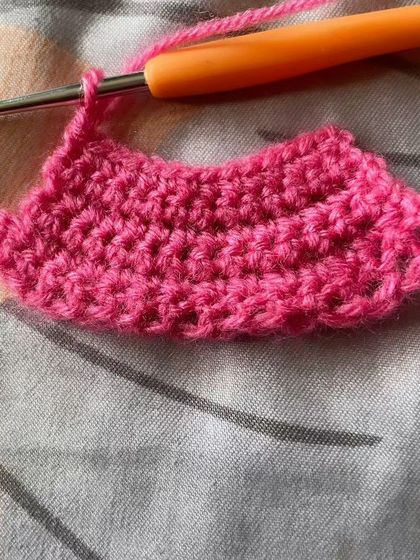 This piece shows a student practicing how to increase stitches to create a curved shape. This is a fundamental skill for making everything from hats to amigurumi toys.