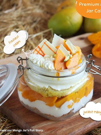 Our premium Mango Jar Cakes are a journey of flavour. This one features the freshest cream, juiciest mangoes, and a crumbly base, all layered in a cute reusable jar.