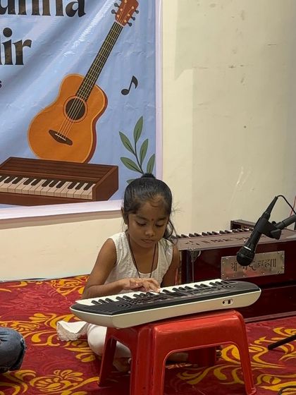 Even our smallest students get their moment in the spotlight. This little one is learning the basics of melody and rhythm on a portable keyboard.