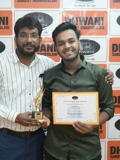 A teacher congratulates his student on his win at the annual art competition.