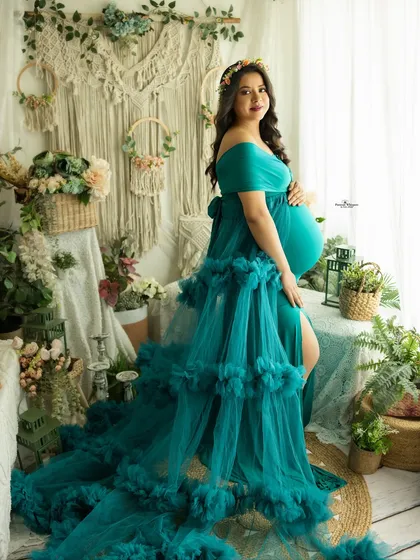 A full-length portrait showcasing a magnificent teal ruffled gown from my client wardrobe. This shot highlights how we use color and texture to create truly unique and memorable maternity photos.