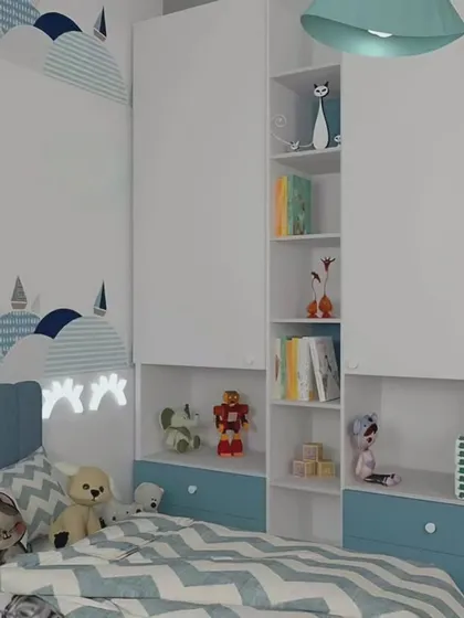 A calm and sweet bedroom design for a child, using a soft blue and white color palette. The custom wardrobe includes open niches for displaying toys and books, keeping the room tidy and personal.