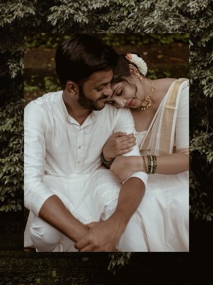 A beautifully framed portrait of a couple in traditional white attire, capturing a moment of serene intimacy.