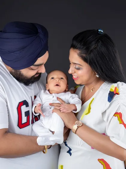A beautiful family portrait with their newborn. Capturing the parents' love and awe as they hold their new baby is a priceless moment.