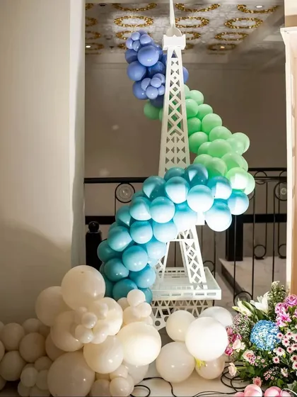 Our miniature Eiffel Tower prop, wrapped in a beautiful gradient of blue and green balloons, serves as a stunning statement piece for a Paris-themed baby shower.