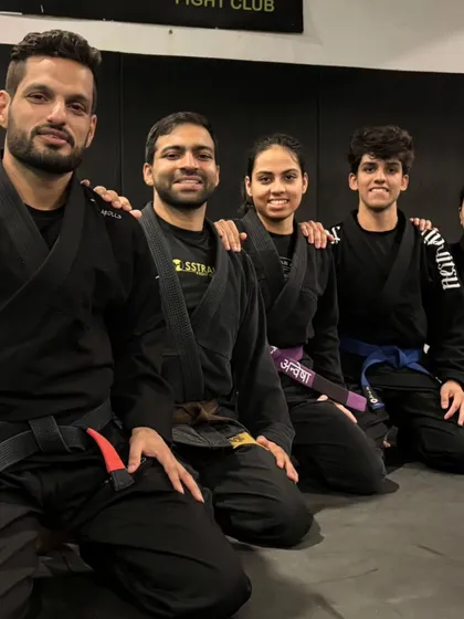 The coaches and teammates who guide the journey. A group photo celebrating a belt promotion, a symbol of collective effort.