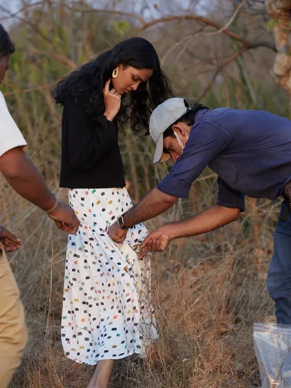 Every detail matters on a commercial shoot. Here, the team works together to ensure the pattern on the skirt is perfectly displayed, demonstrating the meticulous attention required for fashion and lookbook photography.