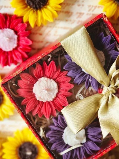 A beautiful gift set of four scented floating candles, crafted in the shape of vibrant sunflowers. These are designed to enhance your festive decor, adding a pop of color and fragrance to your home.